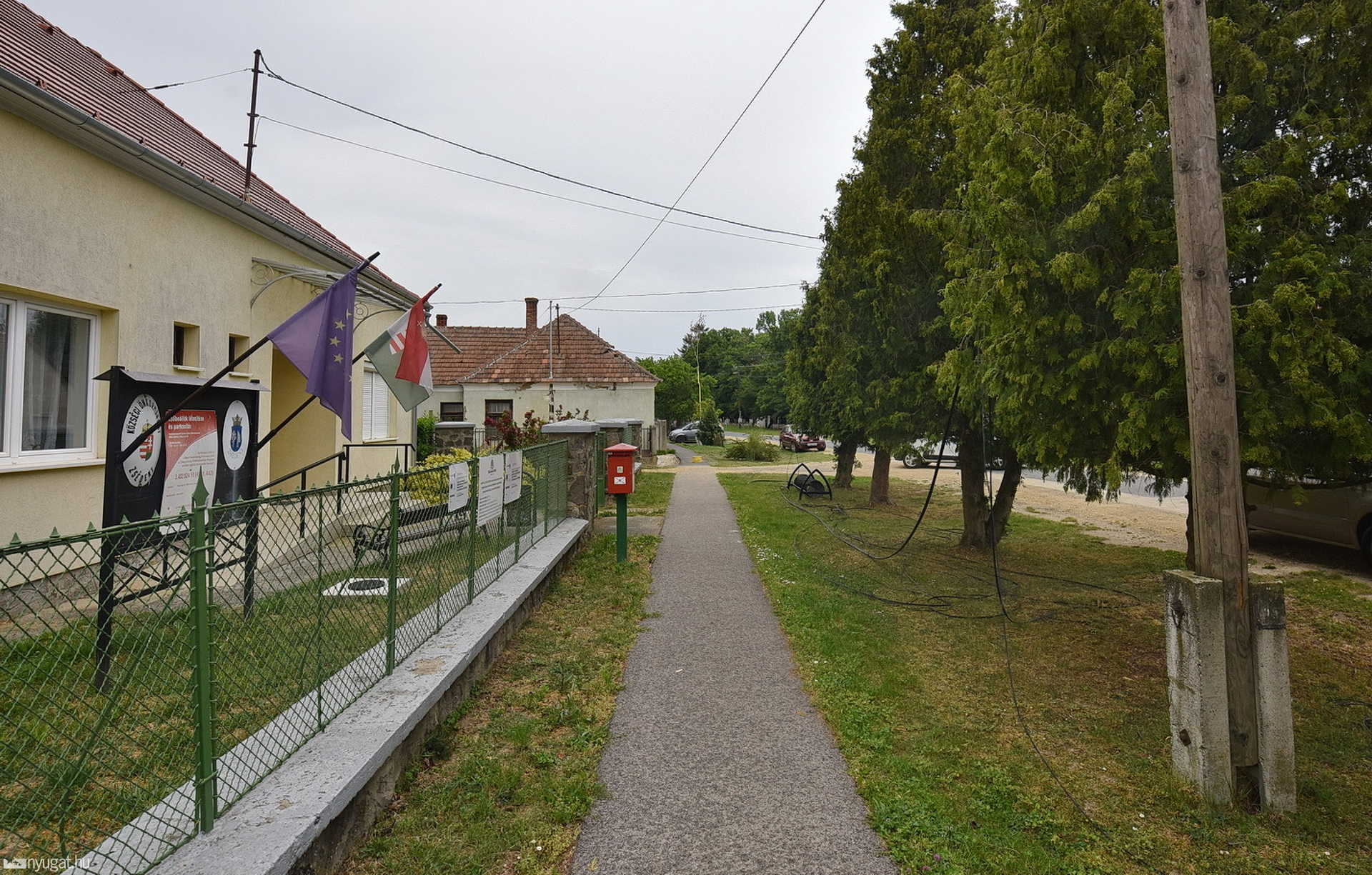 Oszlopot döntött háztetőre a beakadt telefonkábellel egy teherautó Zsédenyben