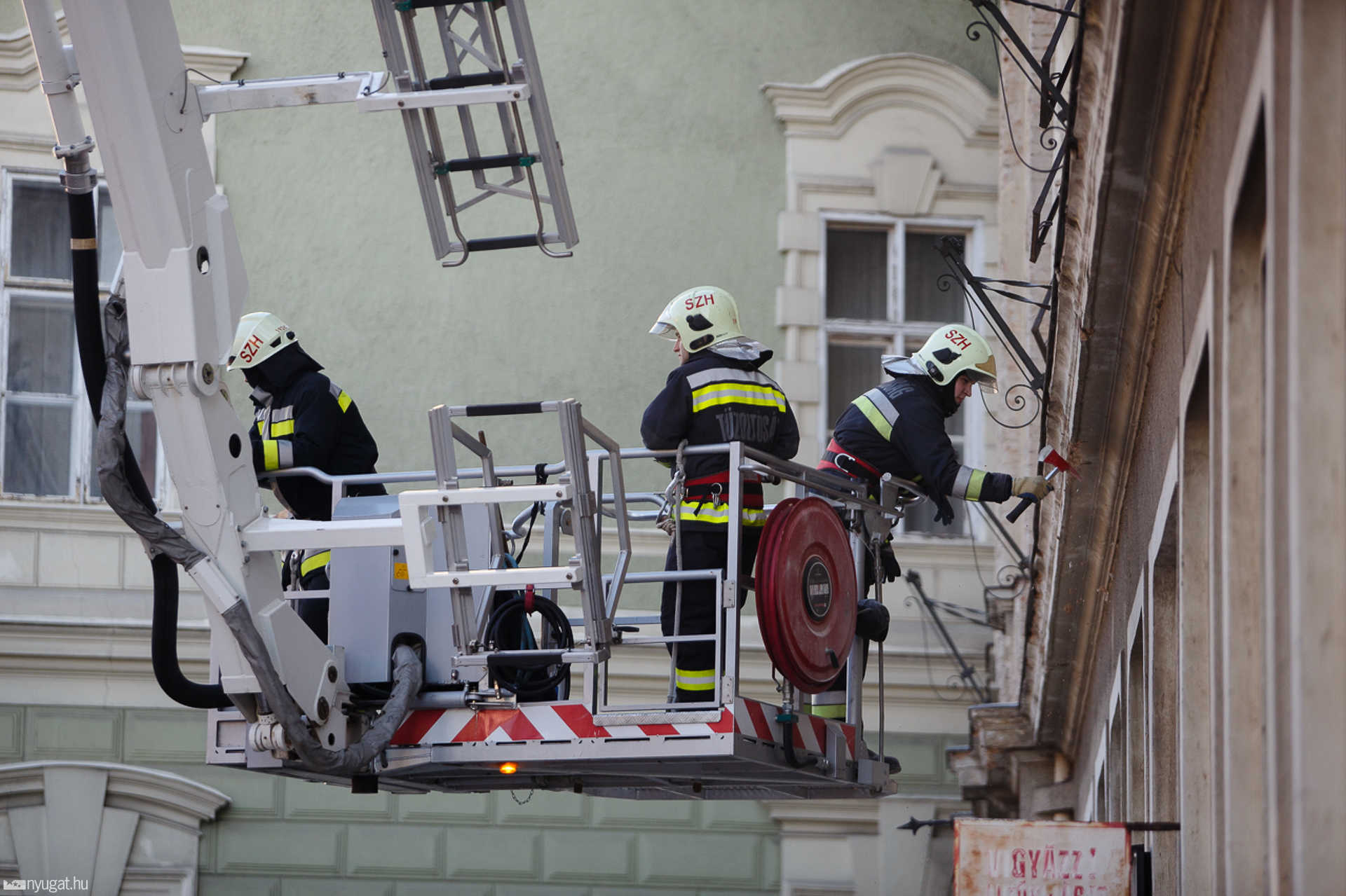 Tűzoltók bontják a Kormányhivatal homlokzatát